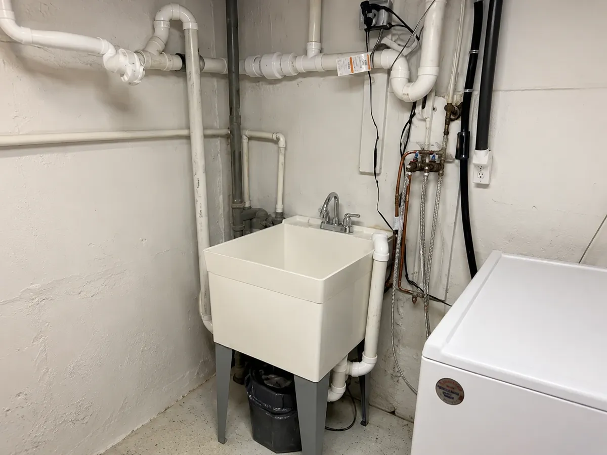 Utility room plumbing repairs and exposed piping by Manzo Plumbing on Long Island